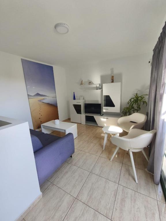 a living room with a couch and a table and chairs at Santa Úrsula 66 in Costa Calma