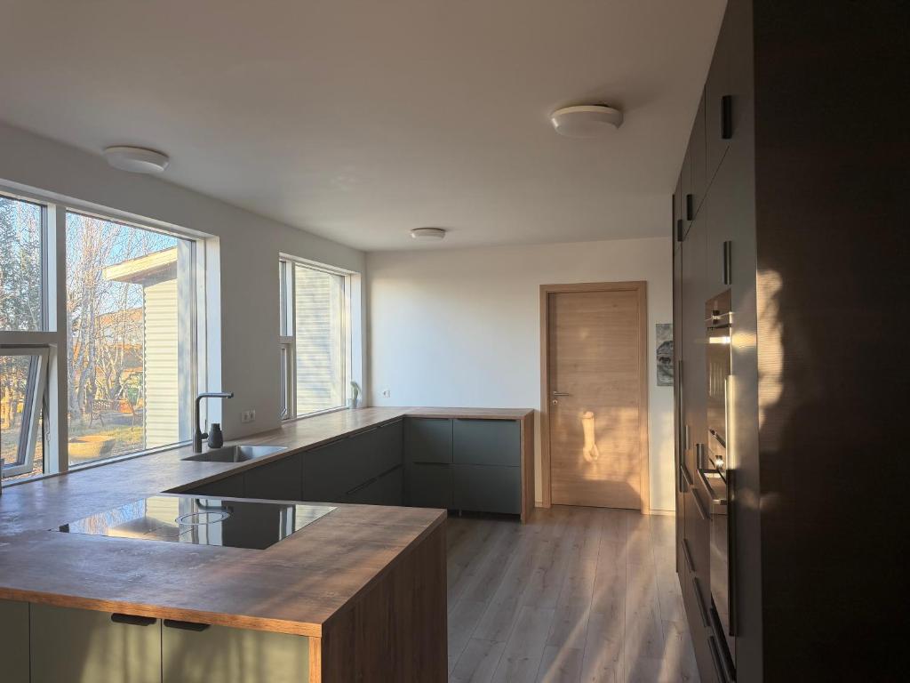 a kitchen with a counter top and a refrigerator at Hugleikshus in Hvolsvöllur
