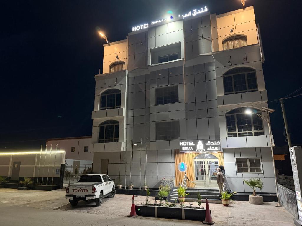 a truck parked in front of a building at night at Hôtel Esma Nouadhibou in Nouadhibou