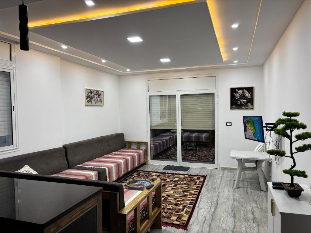a living room with a couch and a table at Appartement vue mer 200m in Rejiche