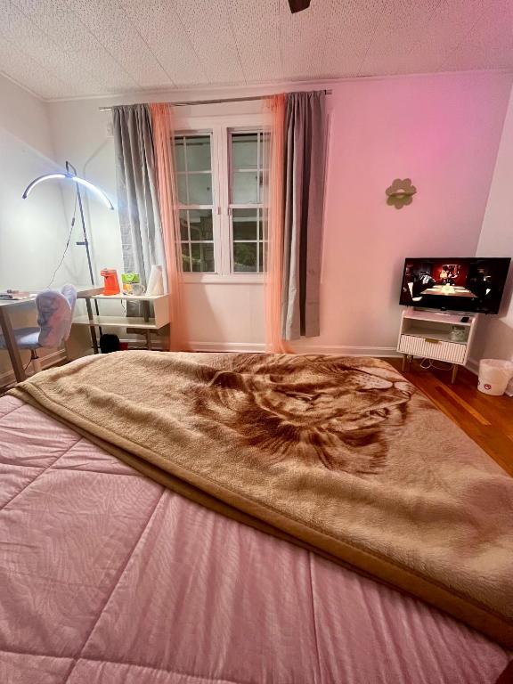a large bed in a bedroom with a large blanket at Bankston A in Marietta