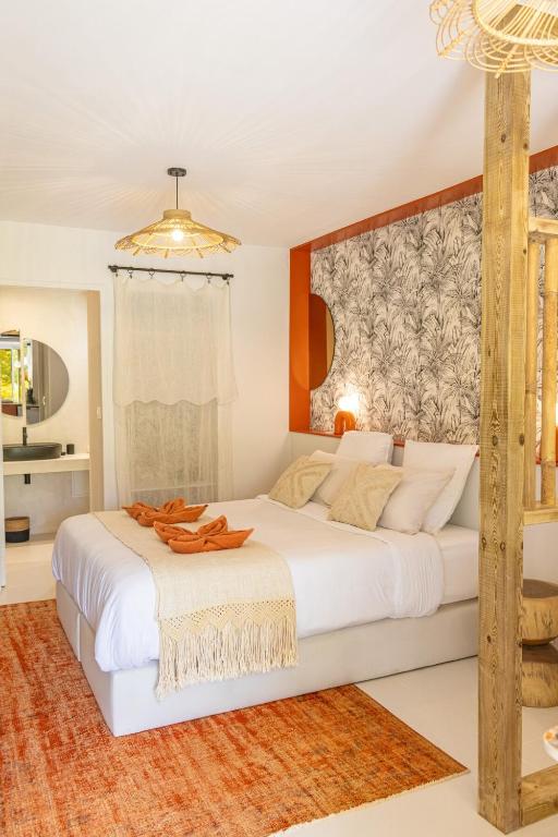 a bedroom with a large white bed in a room at Studio Le Cosy Jungle & Piscine in Pointe-à-Pitre