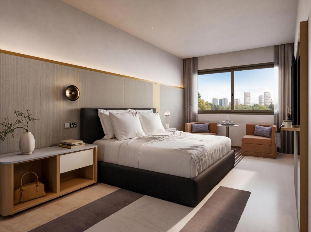 a hotel room with a bed and a window at The Sebel Parramatta in Sydney