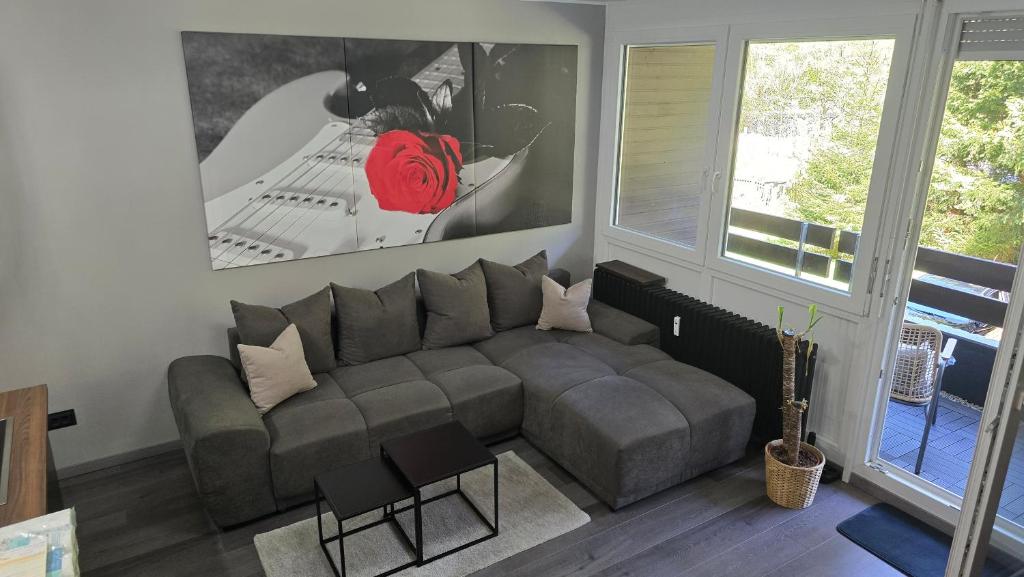 a living room with a couch and a window at WaldLoft in Todtmoos