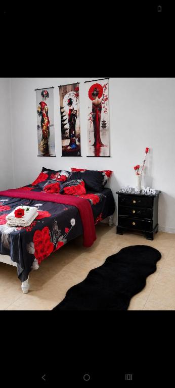 a bedroom with a bed with posters on the wall at Irie Bamboo in Bamboo