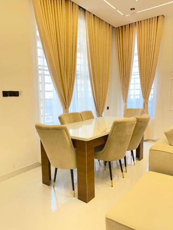 a dining room with a table and chairs at Prince-Coll apartment in Lagos