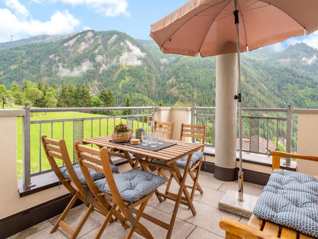 a patio with a table and chairs and an umbrella at Haus Aifnerspitze in Kauns