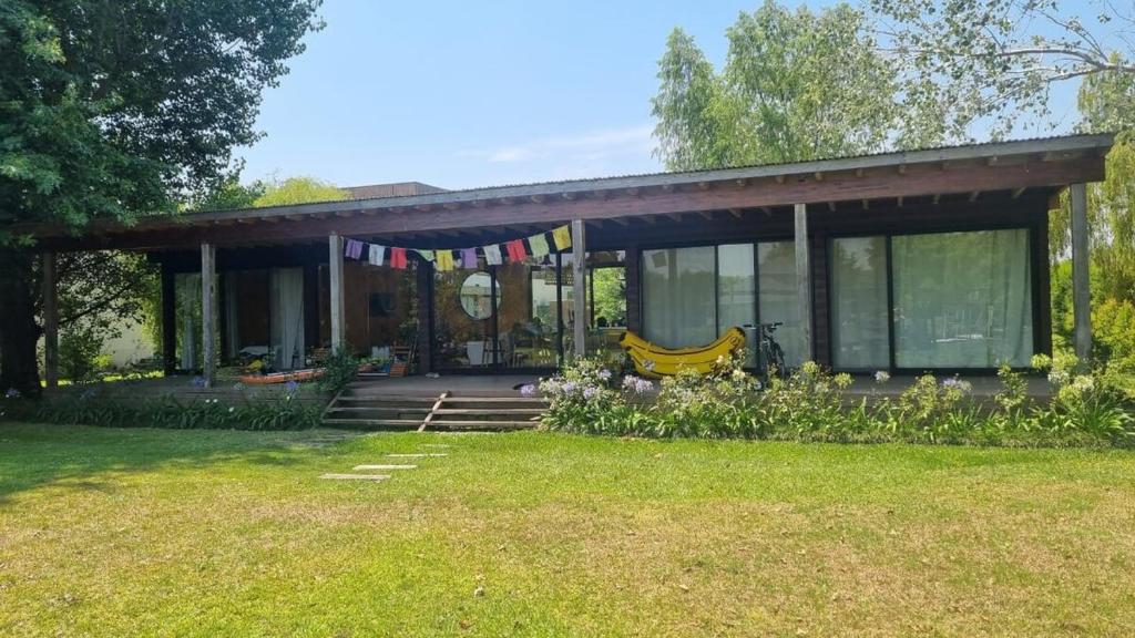 a house with a porch with a banana on it at Cozy Premium Delta Cabin Private Dock in Tigre