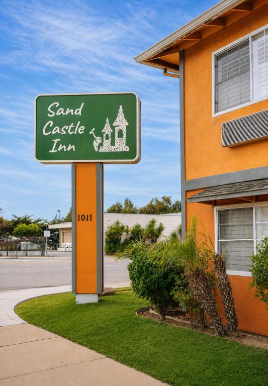 a sign for a sand castle inn in front of a building at Sand Castle Inn in Seaside