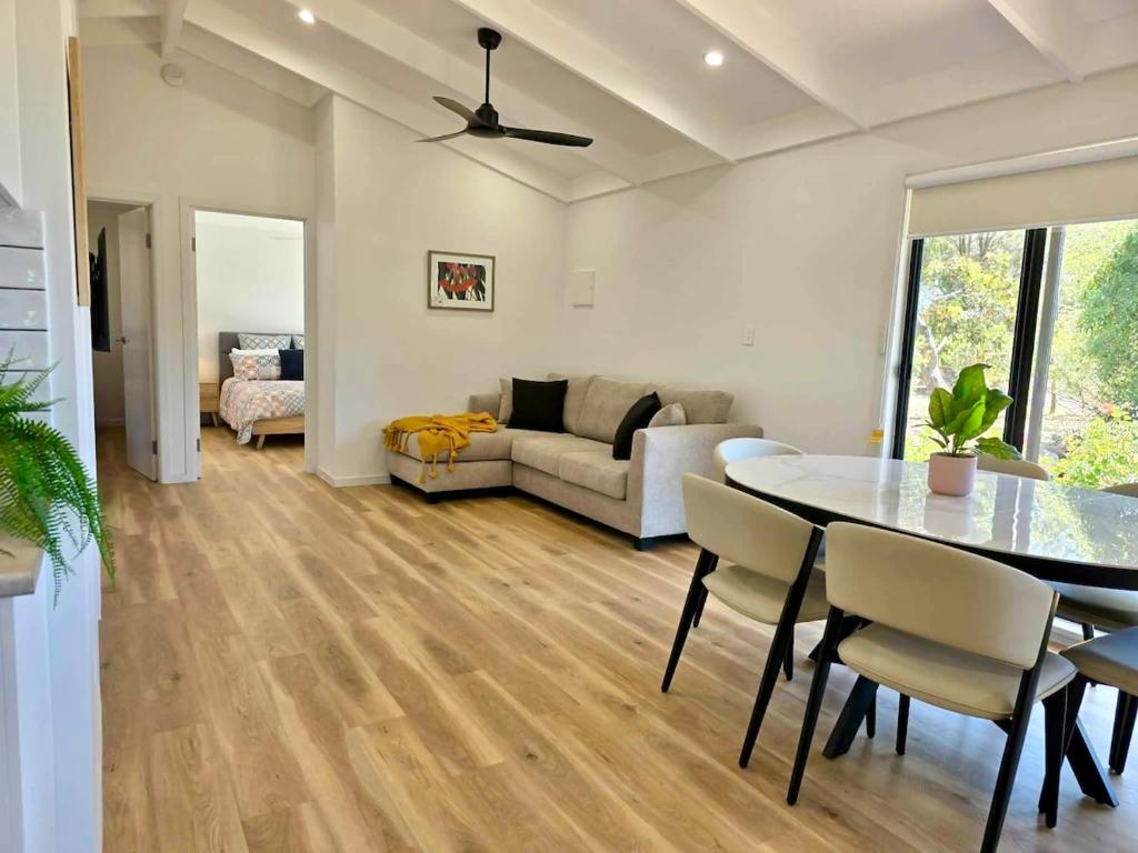 a living room with a table and a couch at Cygnet Escape in Cygnet River