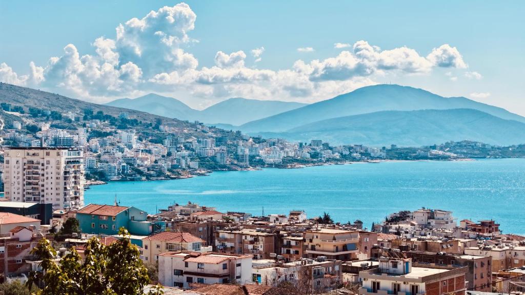 a view of a city with the water and mountains at Davide Rooms in Sarandë