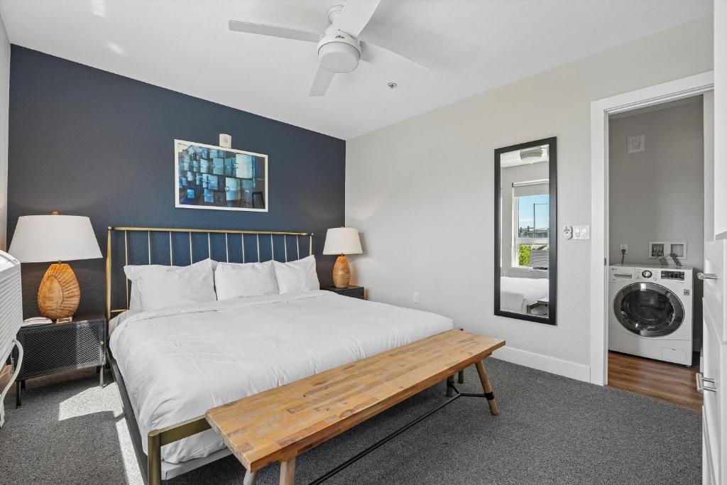 a bedroom with a bed with a wooden bench at Kasa LoHi Denver in Denver