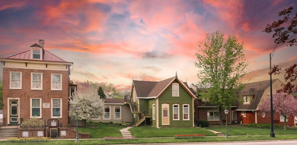 a group of houses on a street with a cloudy sky at Strawtown Inn & Events in Pella