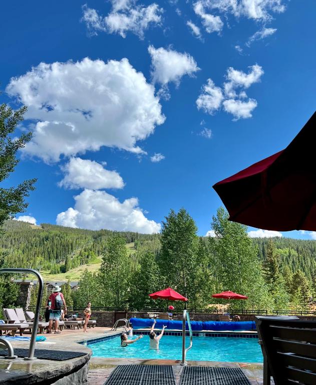 a pool at a resort with people swimming at Dakota Lodge 8503 by SummitCove Lodging in Colorado in Keystone