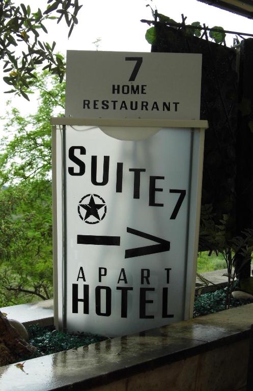 a sign for a hotel with arrows on it at Suite 7 &Home Restaurant in Paglieta