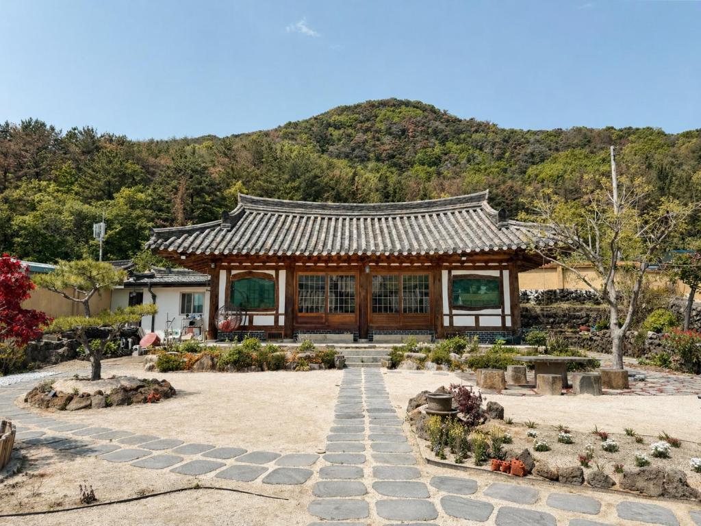 a pavilion in a garden with a mountain in the background at 스테이여온 in Miryang