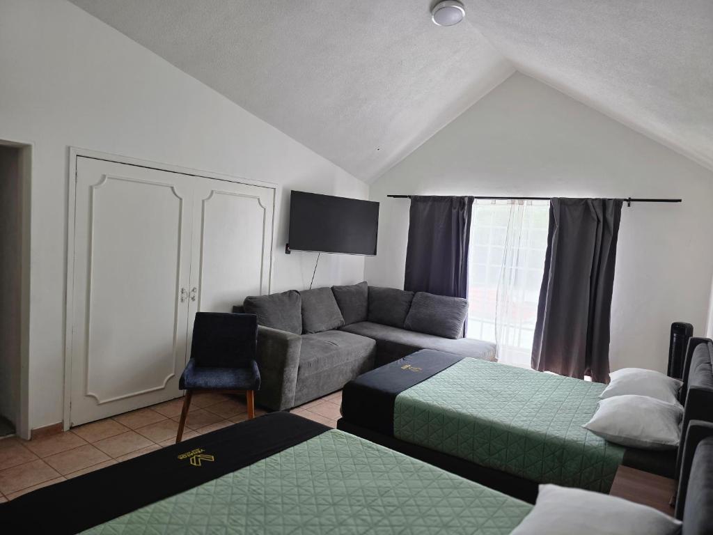 a living room with two beds and a couch at 24 Habitación doble cama in Miravalle