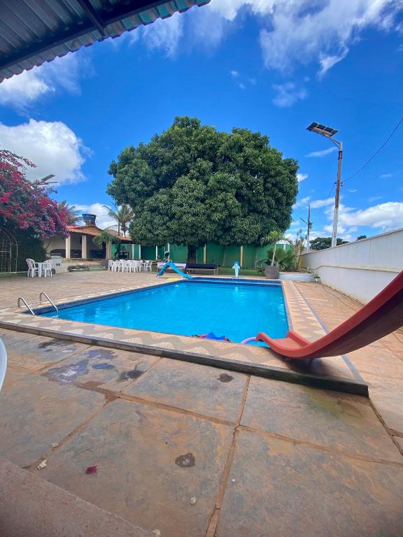 a swimming pool with a hammock next to a tree at Sítio Relax in Tianguá