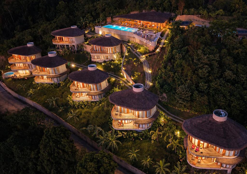 an aerial view of a resort at night with lights at Atalaya Resort El Nido in El Nido