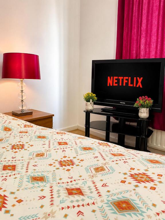 a bedroom with a bed with a netflix sign on it at Cozy Corner in Wolverhampton City Centre in Wolverhampton