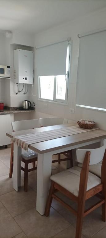 a kitchen with a table and chairs in a kitchen at Pleno Centro in Viedma