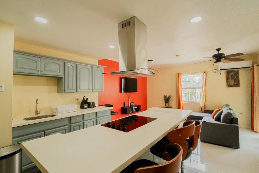 a kitchen with a white counter top in a room at Central 2 bed Apt near Devon House in Kingston