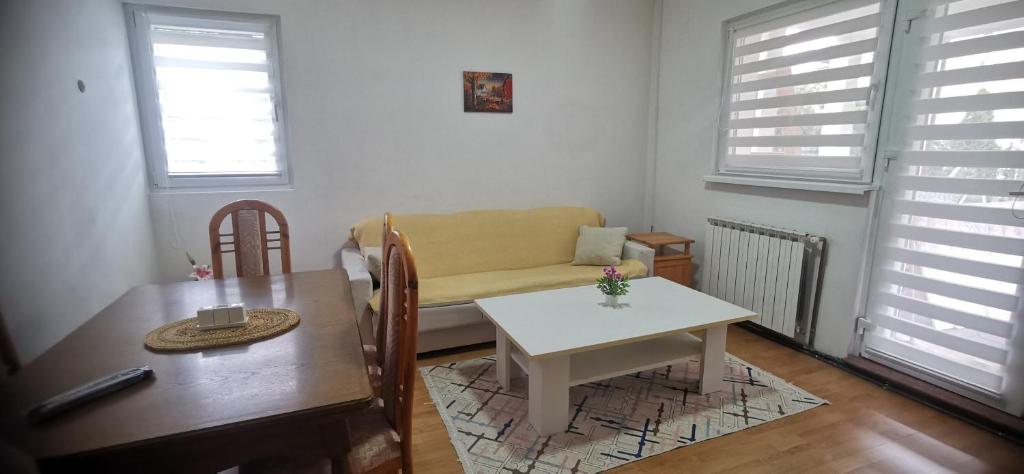 a living room with a table and a couch at 2 BDR Family Apartment In Sarajevo - Free Parking in Sarajevo