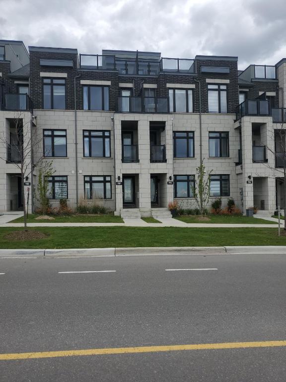 a large building on the side of a street at Lake breeze water view in Bowmanville