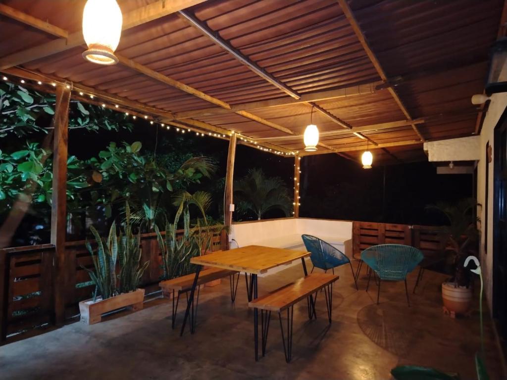 a patio with a wooden table and chairs at Casa en el campo - villeta in Villeta