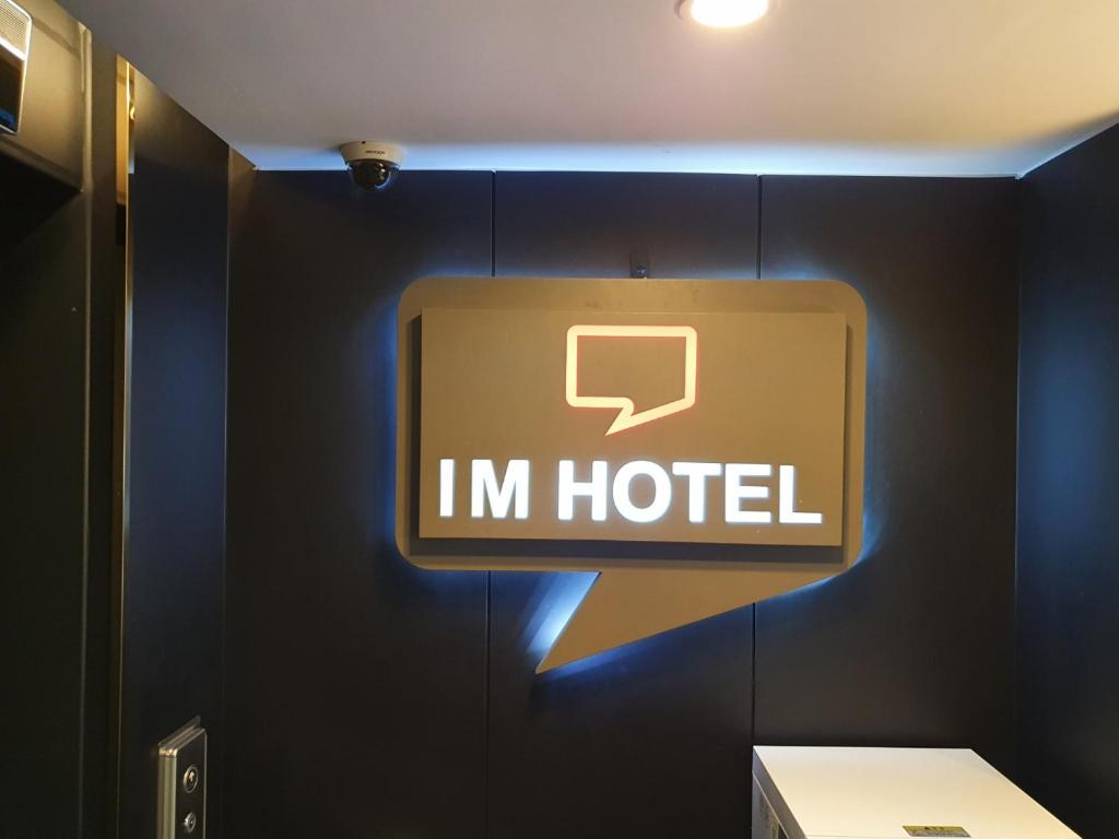 a sign that says im hotel on a wall at IM Hotel in Seoul