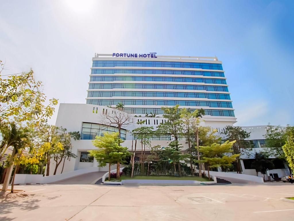 a building with a sign on top of it at Fortune Hotel Korat- SHA Plus in Nakhon Ratchasima