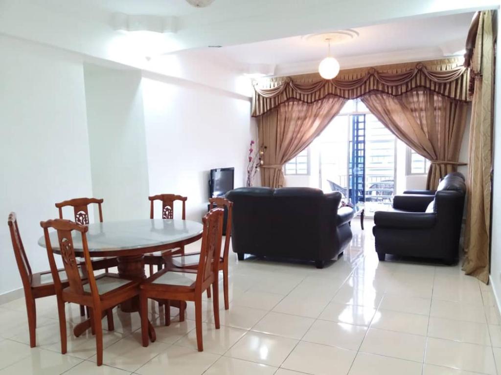a living room with a table and chairs and a couch at Crown imperial in Brinchang