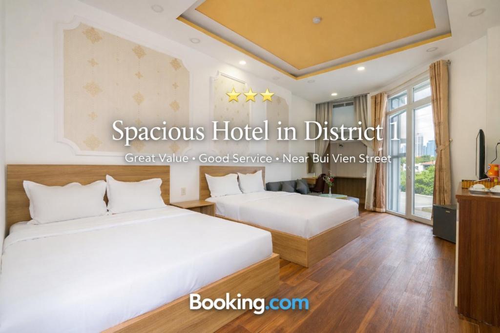 a hotel room with two beds and a tv at Rocky Hotel Ho Chi Minh in Ho Chi Minh City