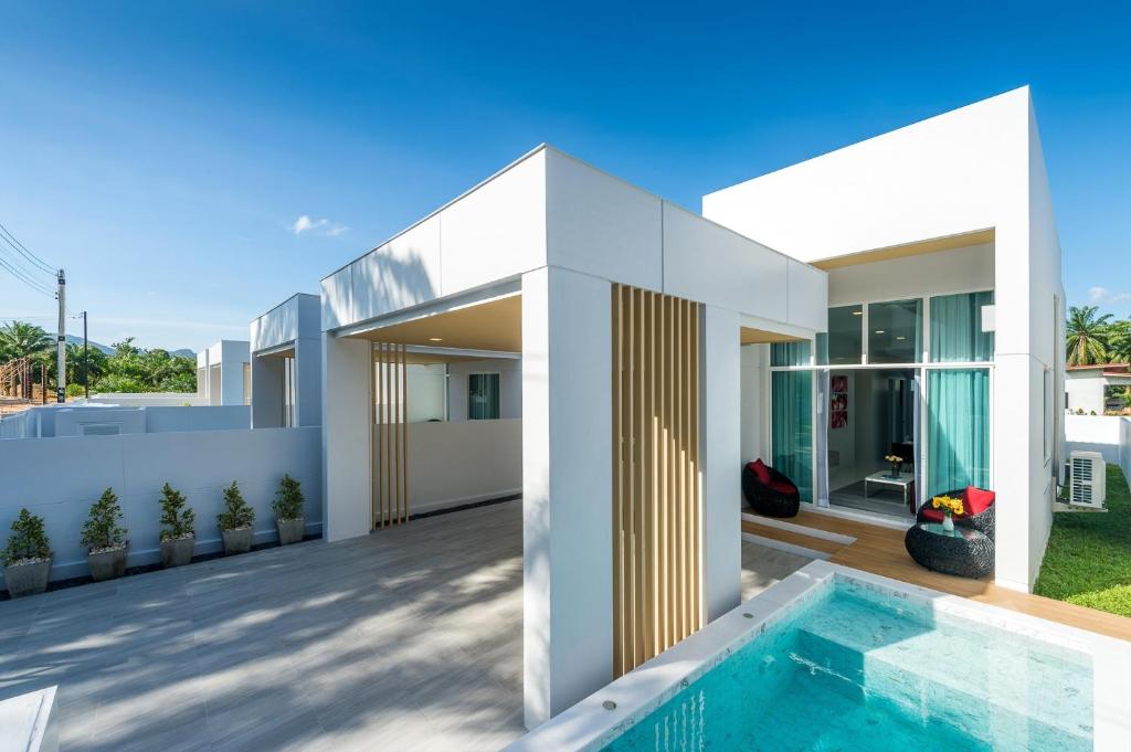 a house with a swimming pool in front of it at The Garnet Light Pool Villa Aonang-3BR Private Pool Villa in Ao Nang Beach