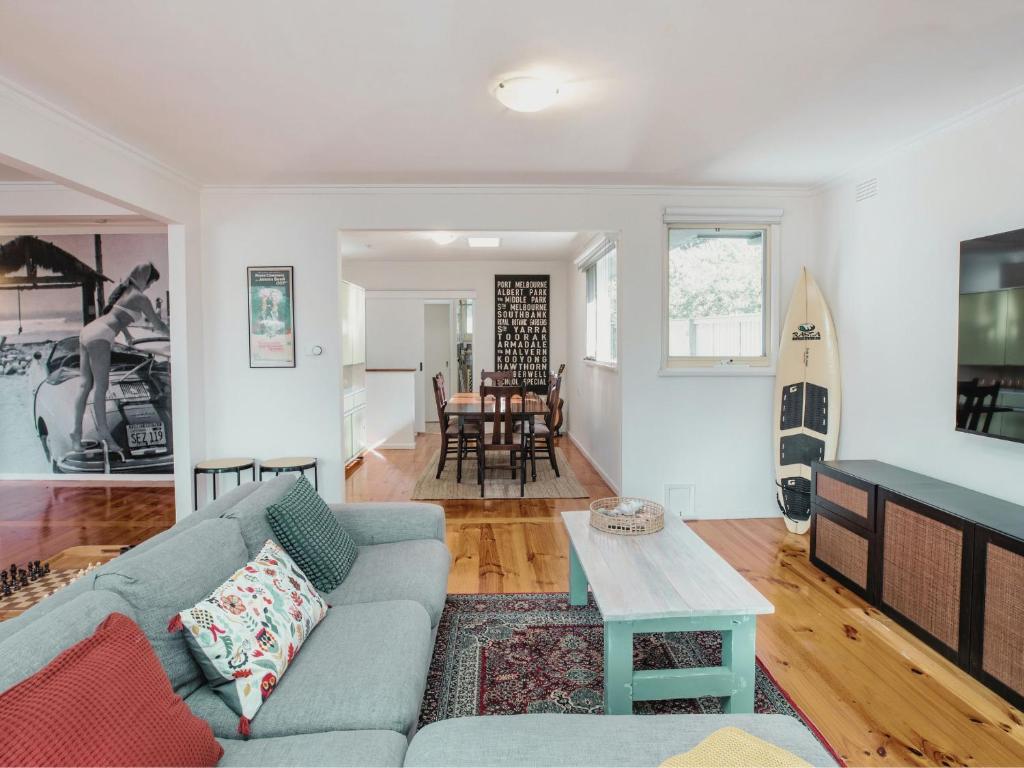 a living room with a couch and a table at Aurora in Queenscliff