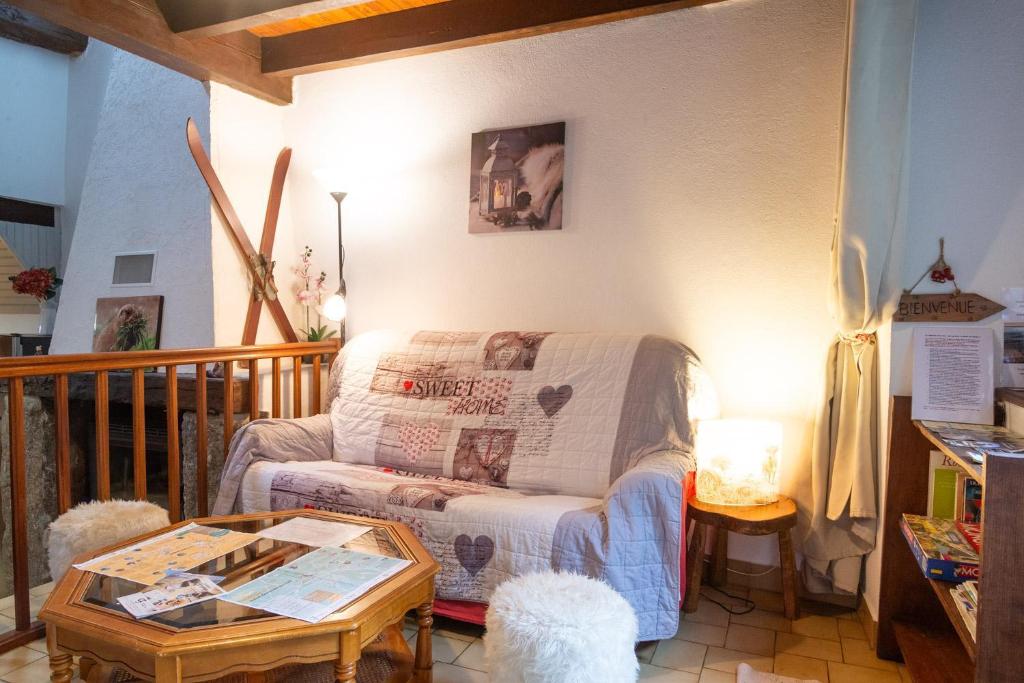 a living room with a couch and a coffee table at La grange - 4/6 personnes in Saint-Pierre-de-Nogaret