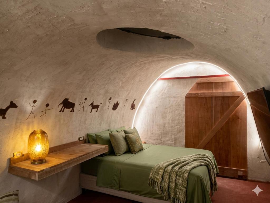 a room with a bed and a wall with a door at Mr Lapin in Santiago Sacatepéquez