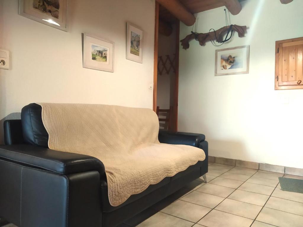 a couch with a blanket on it in a room at La drosera in Lajo
