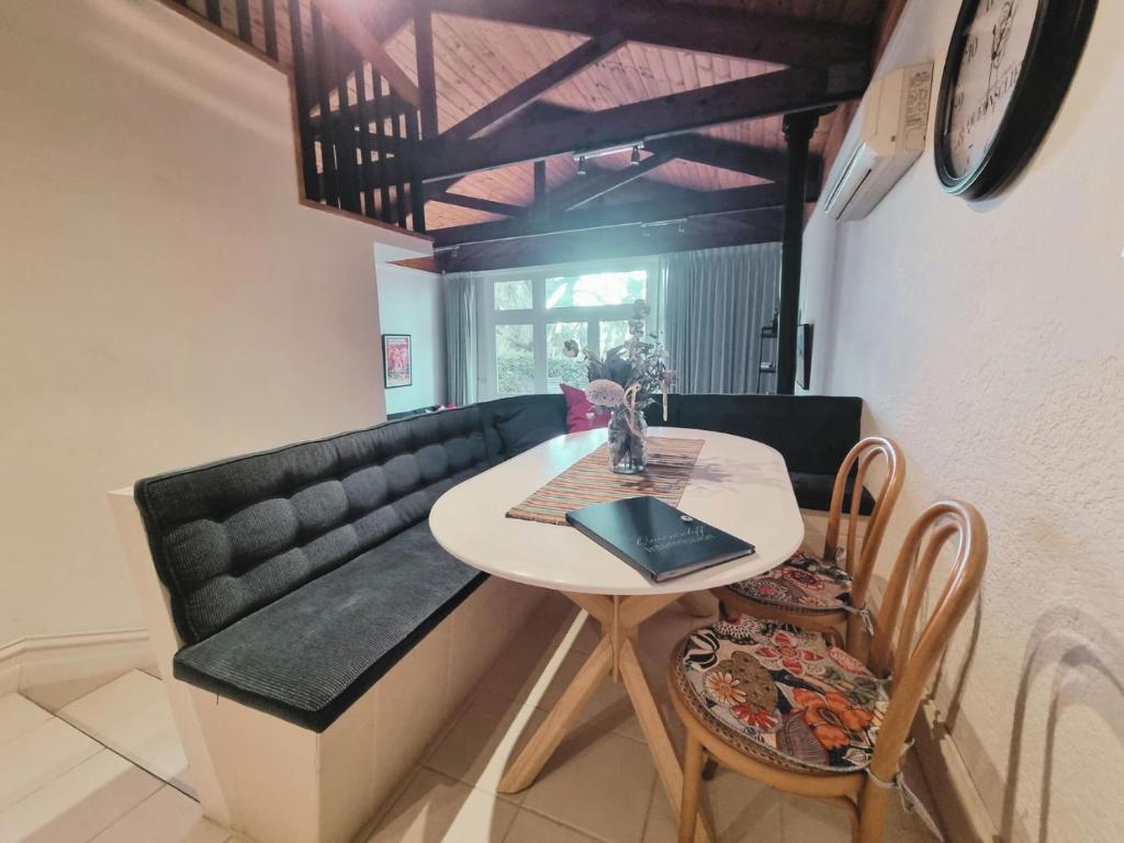 a dining room with a table and a couch at Intermission in Queenscliff