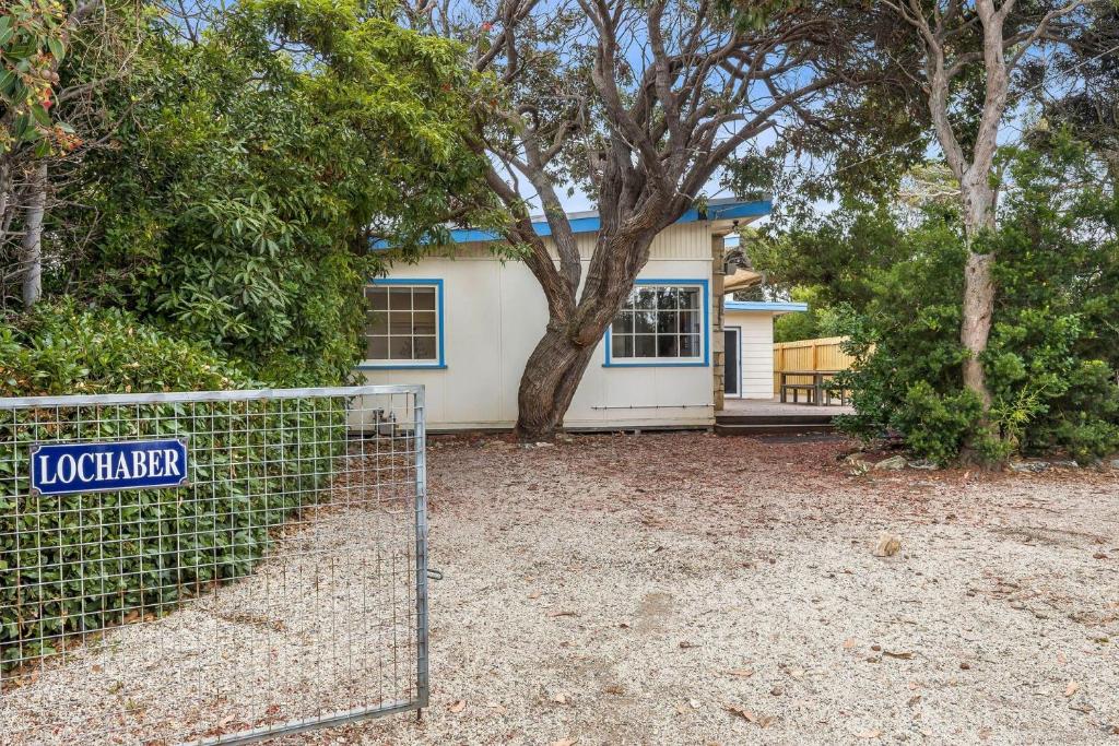 a house with a fence in front of it at Lochaber in Point Lonsdale