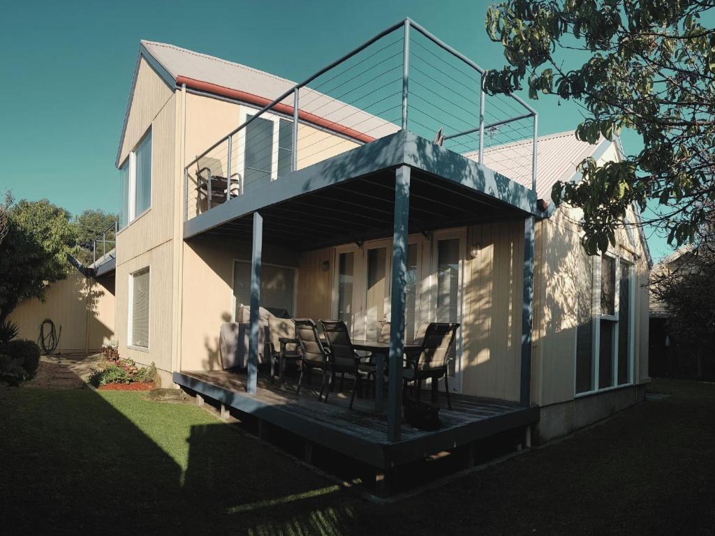 a house with a porch with chairs on it at Lonsdale Shores in Point Lonsdale