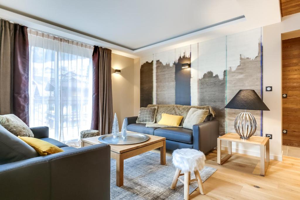 a living room with a couch and a table at Appartements Bétemps in Le Grand-Bornand