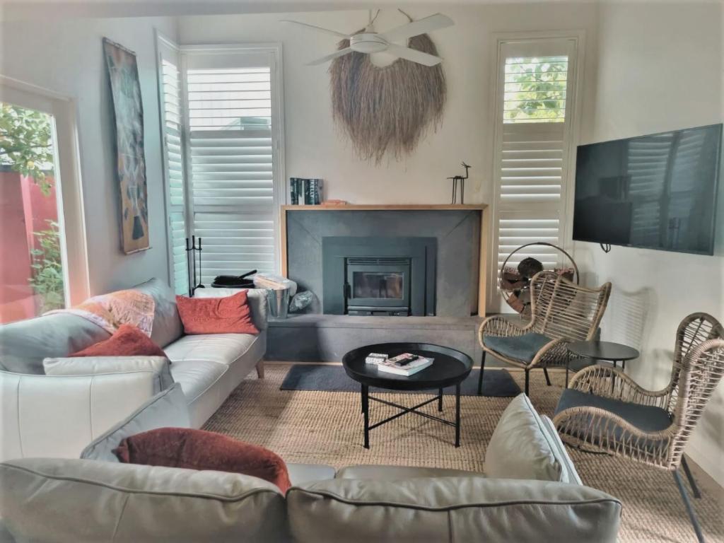 a living room with a couch and a fireplace at Monrepos in Point Lonsdale