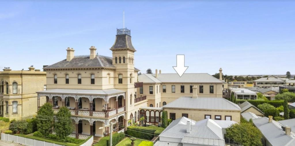 an aerial view of a large mansion with a tower at Penthouse Ozone in Queenscliff