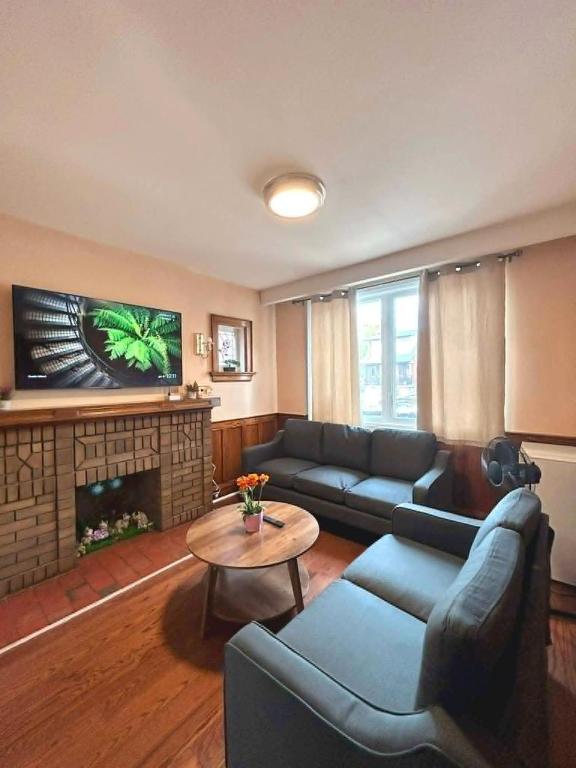 a living room with a couch and a fireplace at TORONTO Midtown HomeHaven in Toronto
