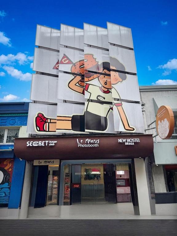 a building with a painting on the side of it at New Hostel Braga in Bandung