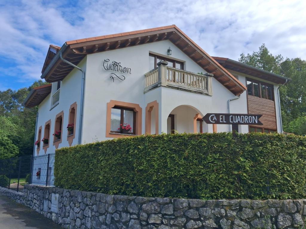 a house with a balcony on top of a stone wall at El Cuadron in Camango