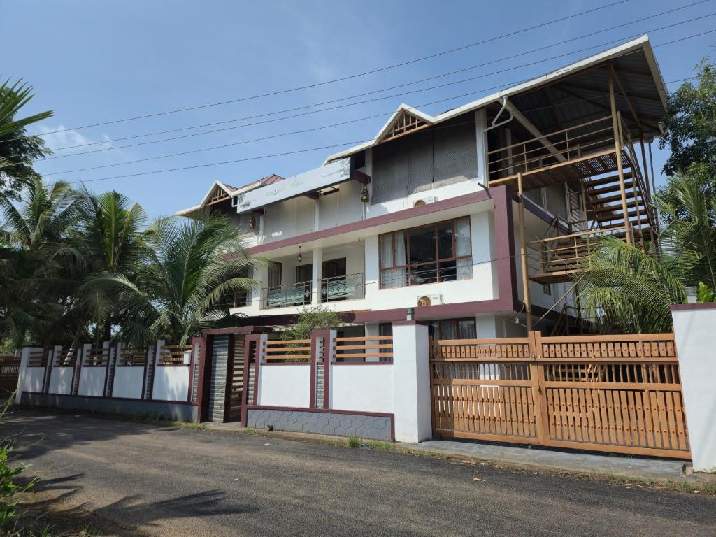 a house with a fence in front of it at Captains Cabin, Alleppey- A Premium Backwater Mansion in Alleppey
