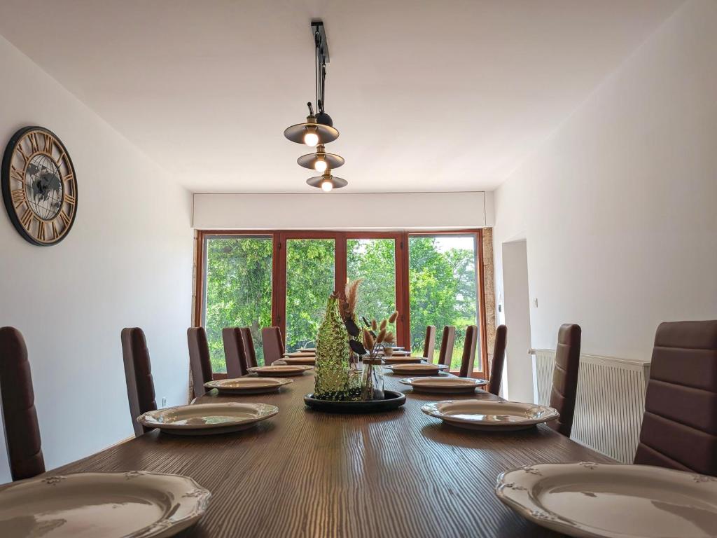 a dining room with a long table with chairs at Gite 15 pers tout compris Les Lucioles in Crevant