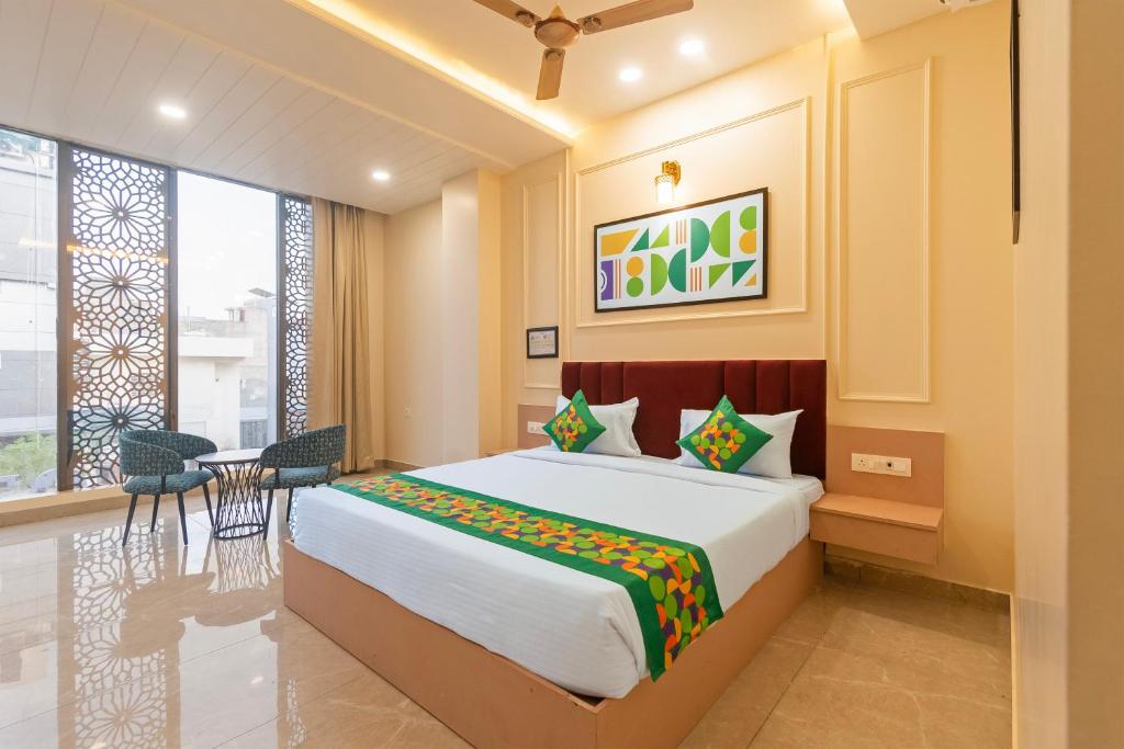 a bedroom with a bed and a table and chairs at Treebo Indus in Jaipur